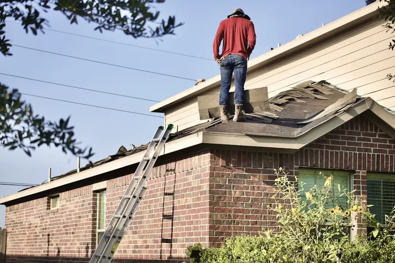 Professional roofer working on a residential roof in Brimhall Estates